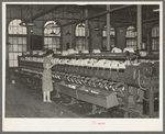 General view of machines where cotton thread is wound onto spools from spindles. Laurel Mills, Laurel, Mississippi