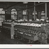 General view of machines where cotton thread is wound onto spools from spindles. Laurel Mills, Laurel, Mississippi