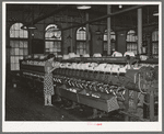 General view of machines where cotton thread is wound onto spools from spindles. Laurel Mills, Laurel, Mississippi