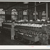 General view of machines where cotton thread is wound onto spools from spindles. Laurel Mills, Laurel, Mississippi