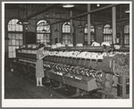 General view of machines where cotton thread is wound onto spools from spindles. Laurel Mills, Laurel, Mississippi