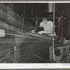 Operator repairing break in thread in warp winding. Laurel cotton mills, Laurel, Mississippi