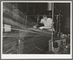 Operator repairing break in thread in warp winding. Laurel cotton mills, Laurel, Mississippi