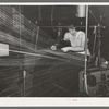 Operator repairing break in thread in warp winding. Laurel cotton mills, Laurel, Mississippi