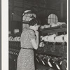 Operator of spool winding machine making knot. When spindles run out these knots are made with machine in her left hand. The small machine costs sixty-five dollars and replaces ten to fifteen operators. Laurel mills, Laurel, Mississippi