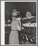 Operator of spool winding machine making knot. When spindles run out these knots are made with machine in her left hand. The small machine costs sixty-five dollars and replaces ten to fifteen operators. Laurel mills, Laurel, Mississippi