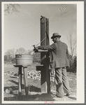 Ed Bagget, sharecropper, drawing water from well. Near Laurel, Mississippi