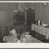 Corner of kitchen and dining room in Ed Bagget's house. Sharecropper kitchen is screened but otherwise open. Near Laurel, Mississippi