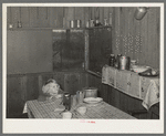 Corner of kitchen and dining room in Ed Bagget's house. Sharecropper kitchen is screened but otherwise open. Near Laurel, Mississippi