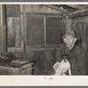Mot Tucker in kitchen of his corncrib home. Note nitrate of soda sacks used for shades in windows. Antioch, Mississippi