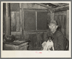 Mot Tucker in kitchen of his corncrib home. Note nitrate of soda sacks used for shades in windows. Antioch, Mississippi