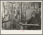 Mot Tucker making ax handles in living room of his corncrib home. Antioch, Mississippi