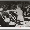 Threading cotton ropes into thread-making machine. Laurel cotton mill, Laurel, Mississippi