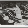 Threading cotton ropes into thread-making machine. Laurel cotton mill, Laurel, Mississippi