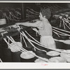 Threading cotton ropes into thread-making machine. Laurel cotton mill, Laurel, Mississippi
