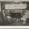 Bagget family in front of fireplace which is means of heating in the winter. Laurel, Mississippi