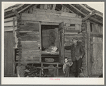 Mot Tucker in front of corncrib home showing sleeping quarters. Antioch, Mississippi