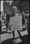 Donna Gottschalk holds "I am your worst fear I am your best fantasy" poster at Christopher Street Gay Liberation Day parade, 1970