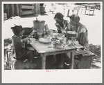 The Caudill family eating dinner in the open the day they were moving their dugout, Pie Town, New Mexico