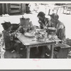 The Caudill family eating dinner in the open the day they were moving their dugout, Pie Town, New Mexico