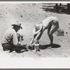 Faro and Doris Caudill cooking dinner over camp fire, Pie Town, New Mexico
