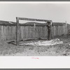 Faro Caudill putting up the center support of his tent, Pie Town, New Mexico