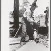 Farmer emptying slush from well which he is drilling with cable tools, Pie Town, New Mexico