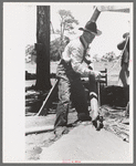 Farmer emptying slush from well which he is drilling with cable tools, Pie Town, New Mexico
