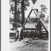 Farmer emptying slush from well which he is drilling with cable tools, Pie Town, New Mexico