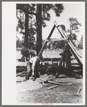 Farmer emptying slush from well which he is drilling with cable tools, Pie Town, New Mexico