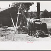 Farmer and his wife drilling water well with cable tools, Pie Town, New Mexico