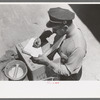 Stage driver making out express receipt, Pie Town, New Mexico