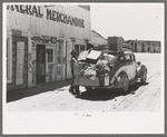 Stage driver unloading packages at general store, Pie Town, New Mexico
