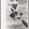 Mrs. Caudill and daughter watering frame garden, Pie Town, New Mexico