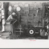 Mrs. Hutton opens electric washing machine. Her son put in all the electric equipment, Pie Town, New Mexico