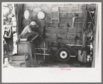 Mrs. Hutton opens electric washing machine. Her son put in all the electric equipment, Pie Town, New Mexico