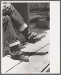 Detail of farmer's blue jeans, boots and spurs. This man was once a cowboy and still prefers the cowboy's dress, Pie Town, New Mexico