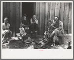 Farm women and children laughing at some antics of the menfolks. This was taken during an all day Sunday visiting to celebrate a birthday, Pie Town, New Mexico