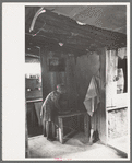 Jack Whinery's daughter washing her hands. This picture was taken in the dugout with natural lighting. Notice the water cooler in cooling room at right. This cooling room is built cellar-like into the ground, Pie Town, New Mexico
