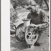 Jack Whinery grinding pinto beans for chicken feed, Pie Town, New Mexico