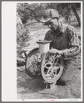 Jack Whinery grinding pinto beans for chicken feed, Pie Town, New Mexico