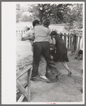 Holding boy to give him a birthday whipping, Pie Town, New Mexico