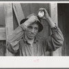 Young mine worker taking lamp from his hat at the end of the day's work, Mogollon, New Mexico