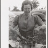 Mrs. Leatherman, homesteader from West Texas taking up chicken and dressing at dinner during the all day community sing, Pie Town, New Mexico