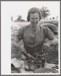 Mrs. Leatherman, homesteader from West Texas taking up chicken and dressing at dinner during the all day community sing, Pie Town, New Mexico