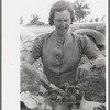 Mrs. Leatherman, homesteader from West Texas taking up chicken and dressing at dinner during the all day community sing, Pie Town, New Mexico