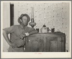 FSA (Farm Security Administration) client leaning on icebox. Hidalgo County, Texas