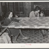 Quilting in sharecropper's home near Pace, Mississippi. Background photo for Sunflower Plantation