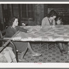 Quilting in sharecropper's home near Pace, Mississippi. Background photo for Sunflower Plantation