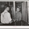 Farmer receiving check for sweet potatoes at starch plant. Laurel, Mississippi